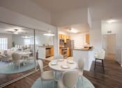 Thumbnail 4 of 14 - a dining room and kitchen with a table and chairs