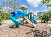 Thumbnail 17 of 22 - A playground with a blue slide and a yellow top.
