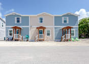 Thumbnail 15 of 22 - A row of houses with a blue sky in the background.