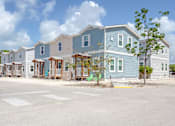 Thumbnail 16 of 22 - A row of houses with a tree in front of the first house.