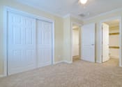 Thumbnail 11 of 24 - A white door is in a room with beige walls.