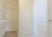 Thumbnail 13 of 24 - Empty white shelves in a small room.