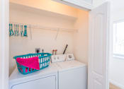 Thumbnail 12 of 29 - a washer and dryer in a laundry room with a basket