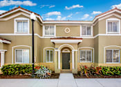 Thumbnail 28 of 29 - a beige house with a sidewalk in front of it