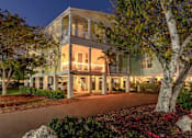 Thumbnail 18 of 20 - A large house with a balcony and a tree in front.