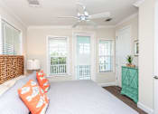 Thumbnail 7 of 20 - A bedroom with a bed, a dresser, and a window with blinds.