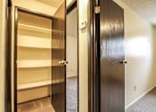 Thumbnail 10 of 17 - A hallway with a black door on the right and a white door on the left.