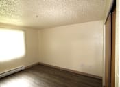 Thumbnail 7 of 15 - A bedroom with a window and a wall-mounted air conditioner.