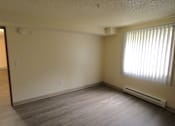 Thumbnail 6 of 15 - A bedroom with a window and an electric heater on the wall.
