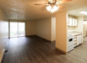 Thumbnail 4 of 15 - The living room with a ceiling fan and wooden flooring.