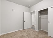 Thumbnail 8 of 24 - a bedroom with a closet with built-in shelving