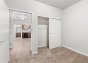 Thumbnail 5 of 24 - a large carpeted bedroom with a double closet with built-in shelving