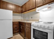Thumbnail 15 of 28 - a kitchen with white appliances and wooden cabinets
