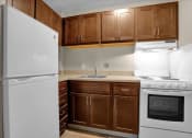 Thumbnail 12 of 28 - a kitchen with white appliances and wooden cabinets