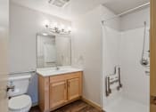Thumbnail 17 of 26 - A bathroom with a toilet, sink, and shower.