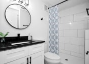 Thumbnail 7 of 36 - a bathroom with a sink and a mirror and a toilet