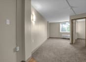 Thumbnail 13 of 28 - an empty living room with a door to a bedroom