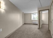 Thumbnail 8 of 28 - the living room and dining room of an empty home with a window