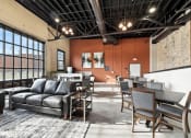 Thumbnail 17 of 25 - the community room with massive windows and ample seating at Brooke Street Lofts