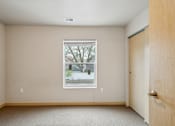 Thumbnail 23 of 26 - A room with a window and a door.