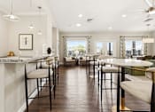 Thumbnail 13 of 41 - A modern kitchen with a bar area and a dining table.