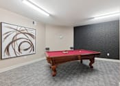 Thumbnail 11 of 19 - A pool table in a room with a painting on the wall.at The Lodge at Johns Road Apartments, Huntsville, AL, 35806