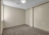 Thumbnail 10 of 28 - an empty room with white walls and a carpeted floor