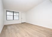 Thumbnail 8 of 36 - an empty living room with white walls and wood-style floors