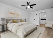 Thumbnail 6 of 36 - a bedroom with a large bed and a ceiling fan