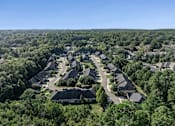 Thumbnail 26 of 28 - A bird's eye view of a residential neighborhood with houses surrounded by trees.