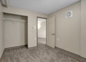 Thumbnail 9 of 28 - a bedroom with a closet and a door to a closet