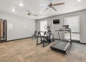 Thumbnail 20 of 24 - the fitness center with cardio equipment and ceiling fans at River Flats