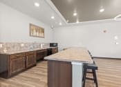 Thumbnail 17 of 24 - a kitchenette area in the community room in River Flats Apartments