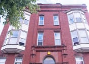 Thumbnail 4 of 12 - a building with a yellow sign on the front of it