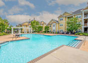 Thumbnail 12 of 56 - large pool and lounge area surrounded by trees and apartment homes at Fenwyck Manor