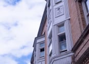 Thumbnail 11 of 12 - a tall building with a clock on the side of it