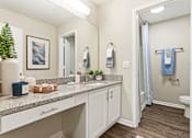 Thumbnail 29 of 41 - A bathroom with a white counter top and a white sink.