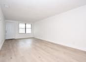 Thumbnail 15 of 36 - an empty living room with white walls and wood-style floors