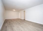 Thumbnail 16 of 36 - an empty living room with white walls and wood-style flooring