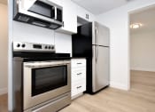 Thumbnail 17 of 36 - a kitchen with a stove and a refrigerator