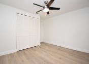 Thumbnail 20 of 36 - an empty room with a ceiling fan and a closet