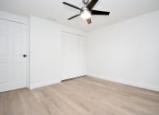 Thumbnail 33 of 36 - an empty living room with white walls and a ceiling fan
