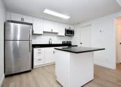 Thumbnail 27 of 36 - a kitchen with white cabinets and a stainless steel refrigerator