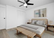 Thumbnail 5 of 36 - a bedroom with a bed and a ceiling fan