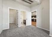 Thumbnail 13 of 25 - a bedroom with a walk-in closet and high ceilings at Brooke Street Lofts