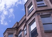 Thumbnail 7 of 12 - a brick building with a blue sky in the background