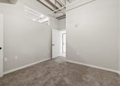 Thumbnail 14 of 25 - a room with a carpeted floor and white walls in a affordable Brooke Street Loft