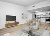 Thumbnail 4 of 36 - a living room with a couch and a table and a television