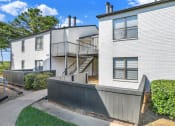 Thumbnail 17 of 18 - newly painted exteriors and lushly landscaped residential buildings