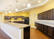 Thumbnail 13 of 26 - A kitchen with a white counter top and brown cabinets.